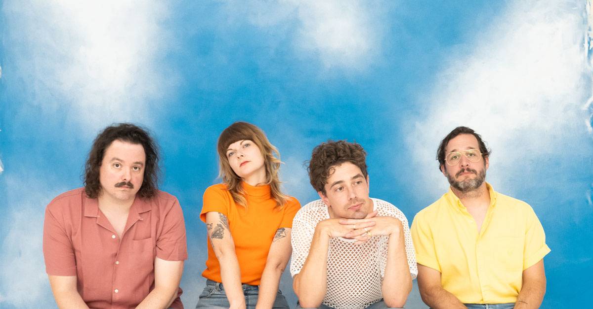 The band born ruffians sitting in front of a backdrop of clouds